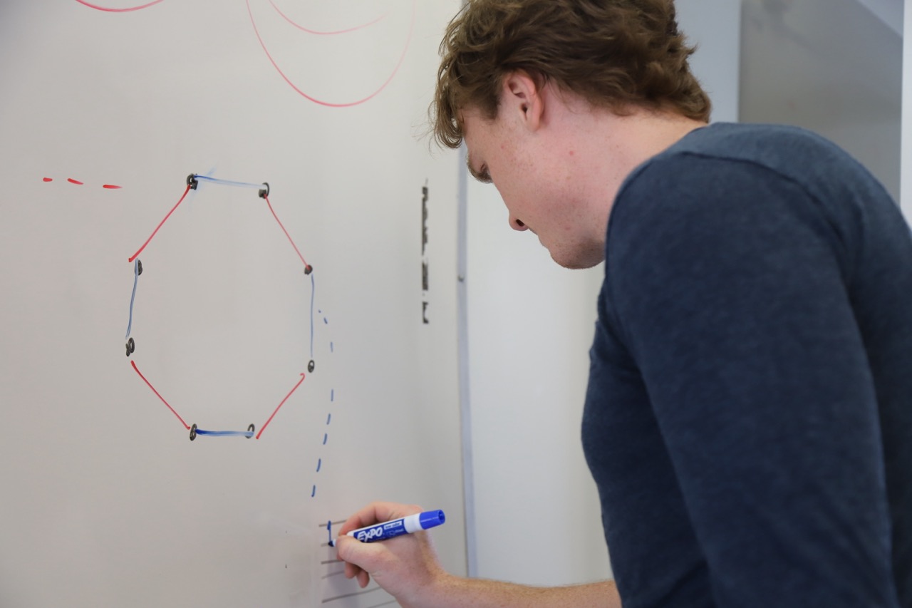 Samuel Bevins working at a whiteboard